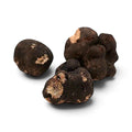 Truffes noires d'hiver fraîches Tuber brumale, de catégorie B, à surface sombre irrégulière et intérieur marbré apparent